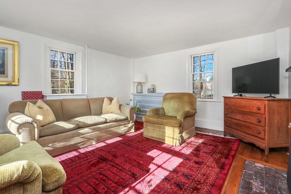 150 Concord Road Sudbury, MA 01776 - Photo 15 of 34 a living room with furniture and a flat screen tv