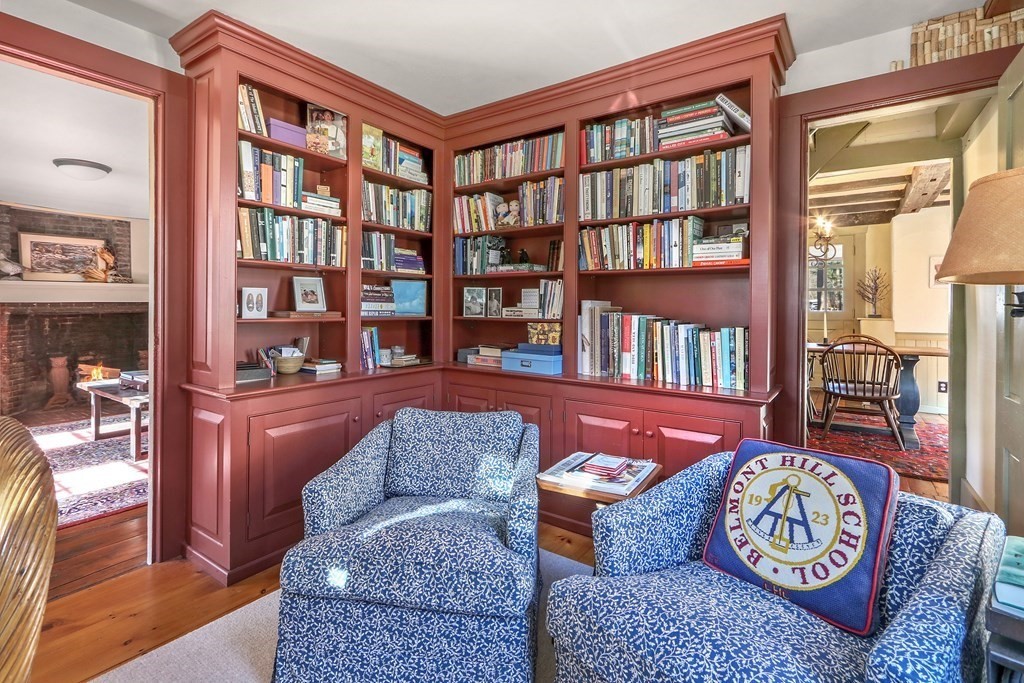 150 Concord Road Sudbury, MA 01776 - Photo 17 of 34 a living room with fireplace furniture and a book shelf