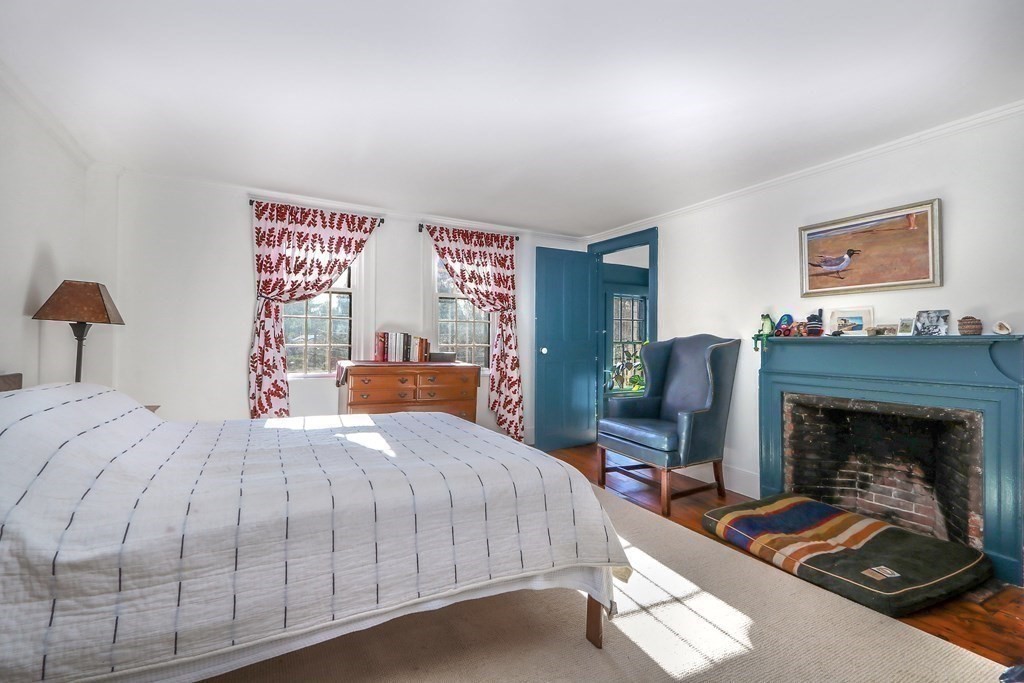 150 Concord Road Sudbury, MA 01776 - Photo 22 of 34 a bedroom with a bed and a fireplace