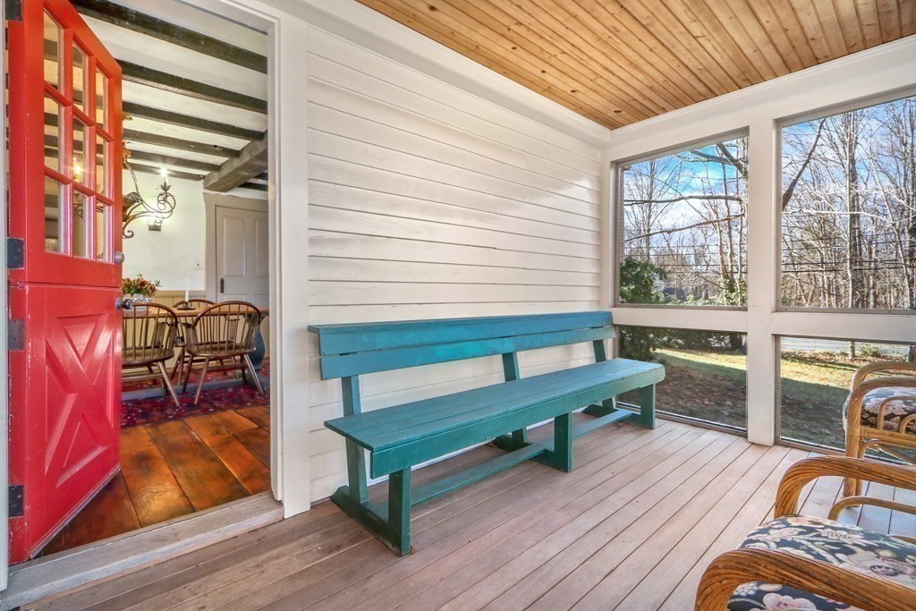 150 Concord Road Sudbury, MA 01776 - Photo 29 of 34 a balcony with wooden floor table and chairs