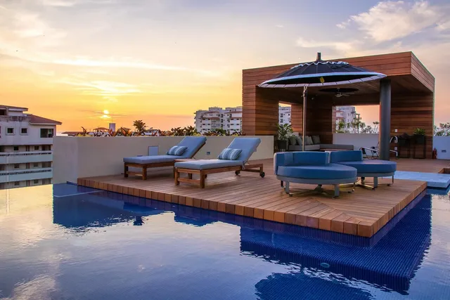 a living room with furniture a fireplace and city view