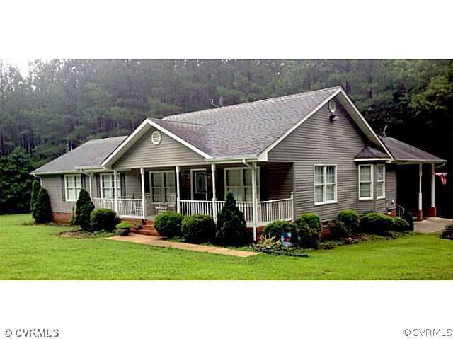 15504 Nash Road Dewitt, VA 23840 - Photo 1 of 18 a front view of a house with a garden