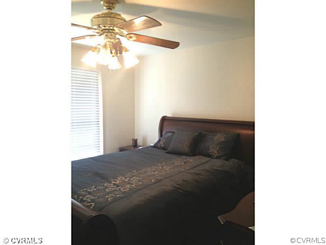 15504 Nash Road Dewitt, VA 23840 - Photo 14 of 18 a bedroom with a bed and a chandelier