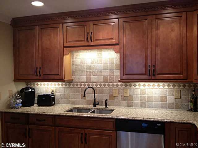 15504 Nash Road Dewitt, VA 23840 - Photo 3 of 18 a kitchen with granite countertop stainless steel appliances a sink window and cabinets