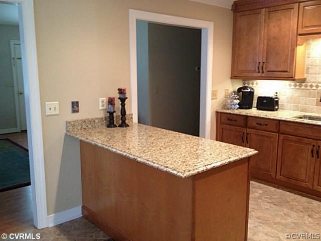 15504 Nash Road Dewitt, VA 23840 - Photo 4 of 18 a kitchen with stainless steel appliances granite countertop a sink stove and refrigerator
