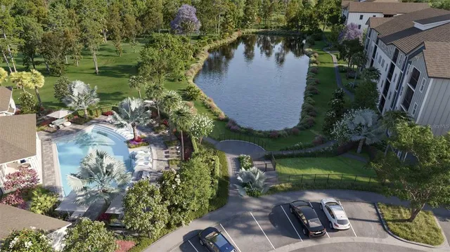 an aerial view of a house with garden space and lake view