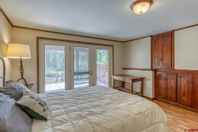 a bedroom with a bed and a large window