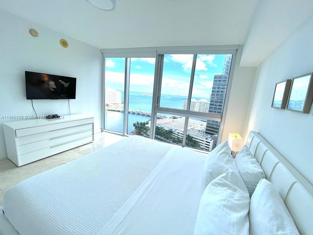 Brickell Miami, FL 33131 - Photo 19 of 27 a bedroom with a bed and a television