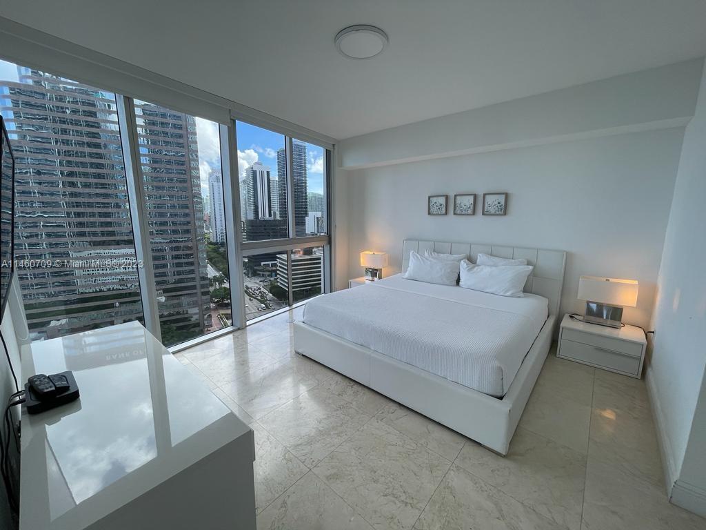 Brickell Miami, FL 33131 - Photo 20 of 27 a bedroom with a large bed and a walk in closet