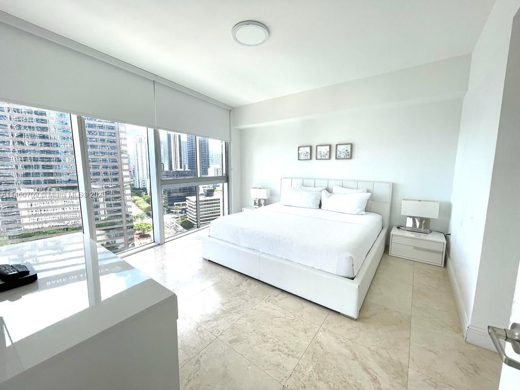 Brickell Miami, FL 33131 - Photo 21 of 27 a bedroom with a large bed and a large window