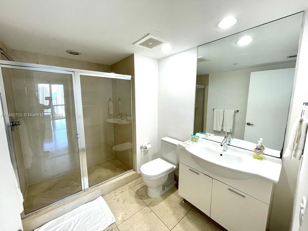 Brickell Miami, FL 33131 - Photo 22 of 27 a bathroom with a double vanity sink toilet and shower