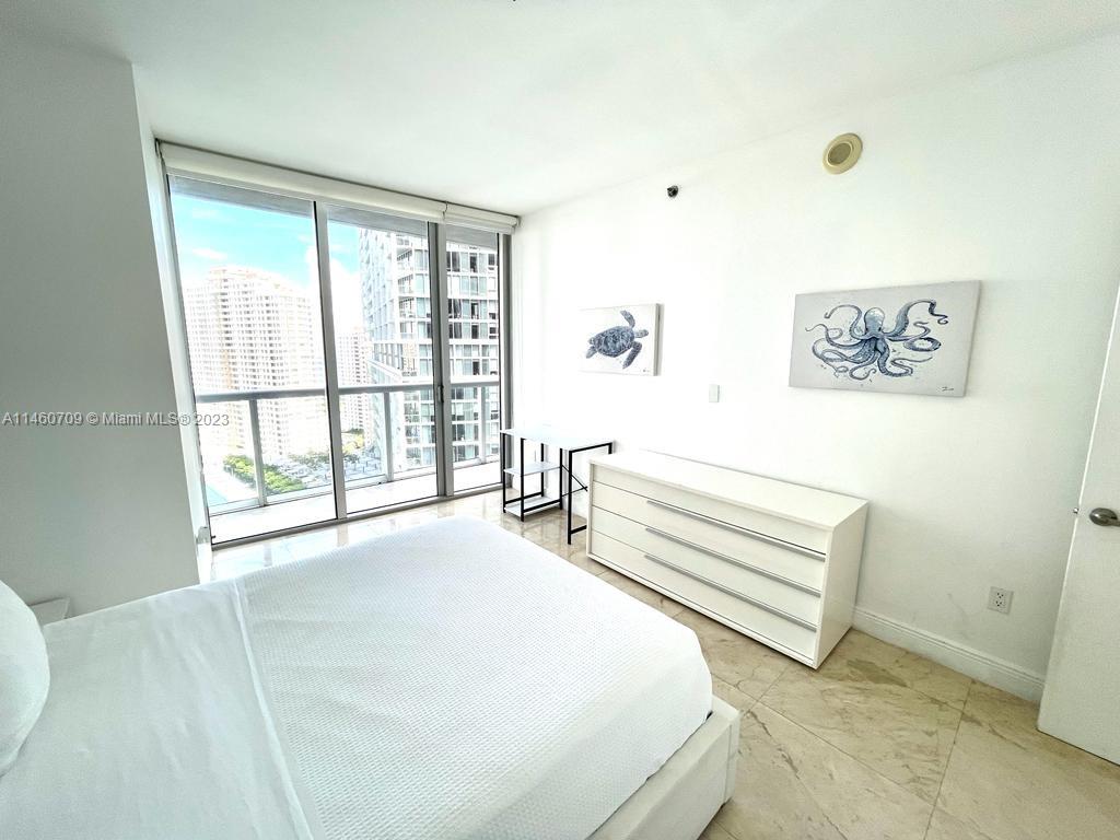 Brickell Miami, FL 33131 - Photo 23 of 27 a spacious bedroom with a bed and a large window