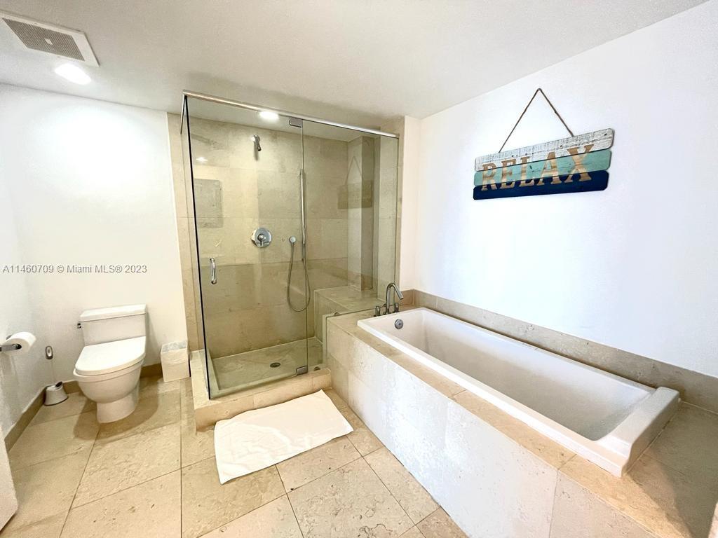 Brickell Miami, FL 33131 - Photo 24 of 27 a bathroom with a toilet a sink and bathtub