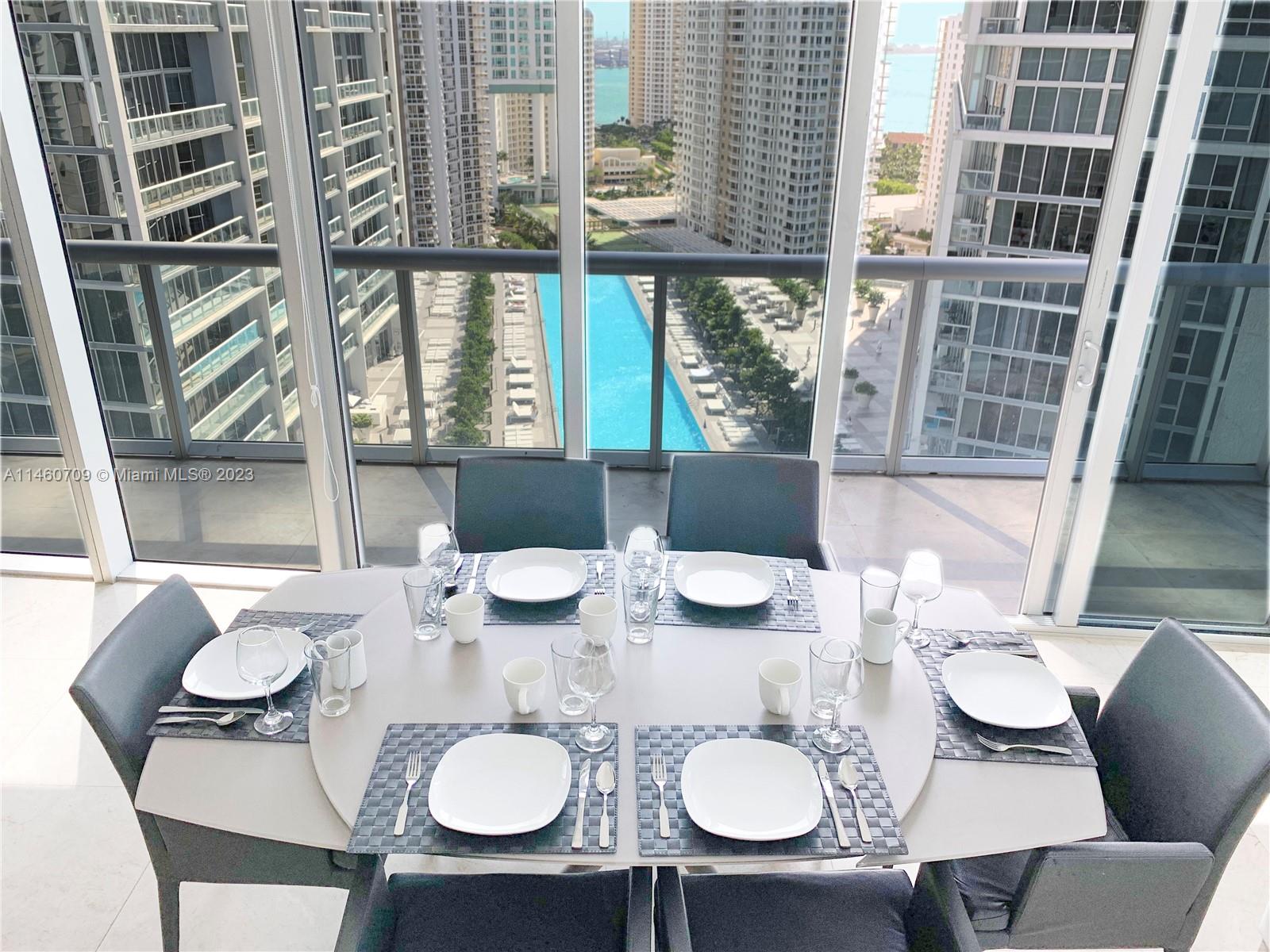 Brickell Miami, FL 33131 - Photo 3 of 27 a view of a dining room with furniture window and wooden floor