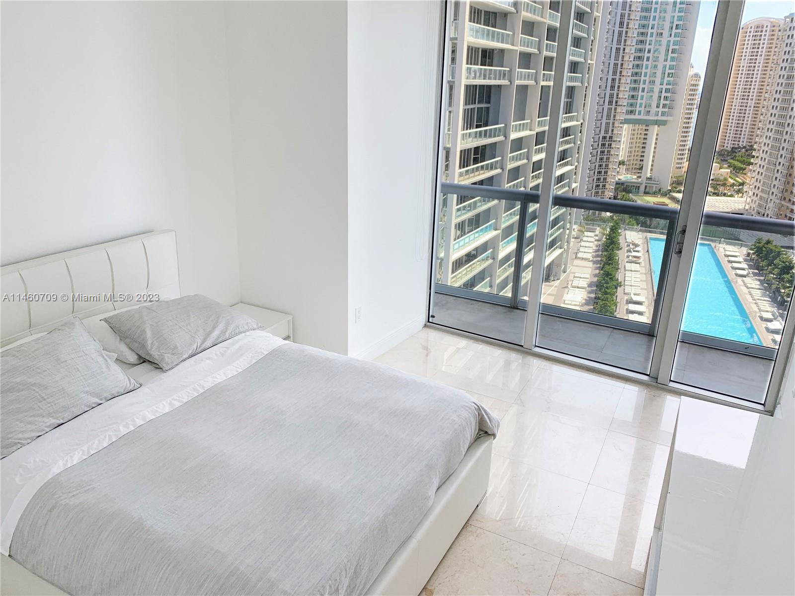 Brickell Miami, FL 33131 - Photo 5 of 27 a bedroom with a bed and a window with outer view