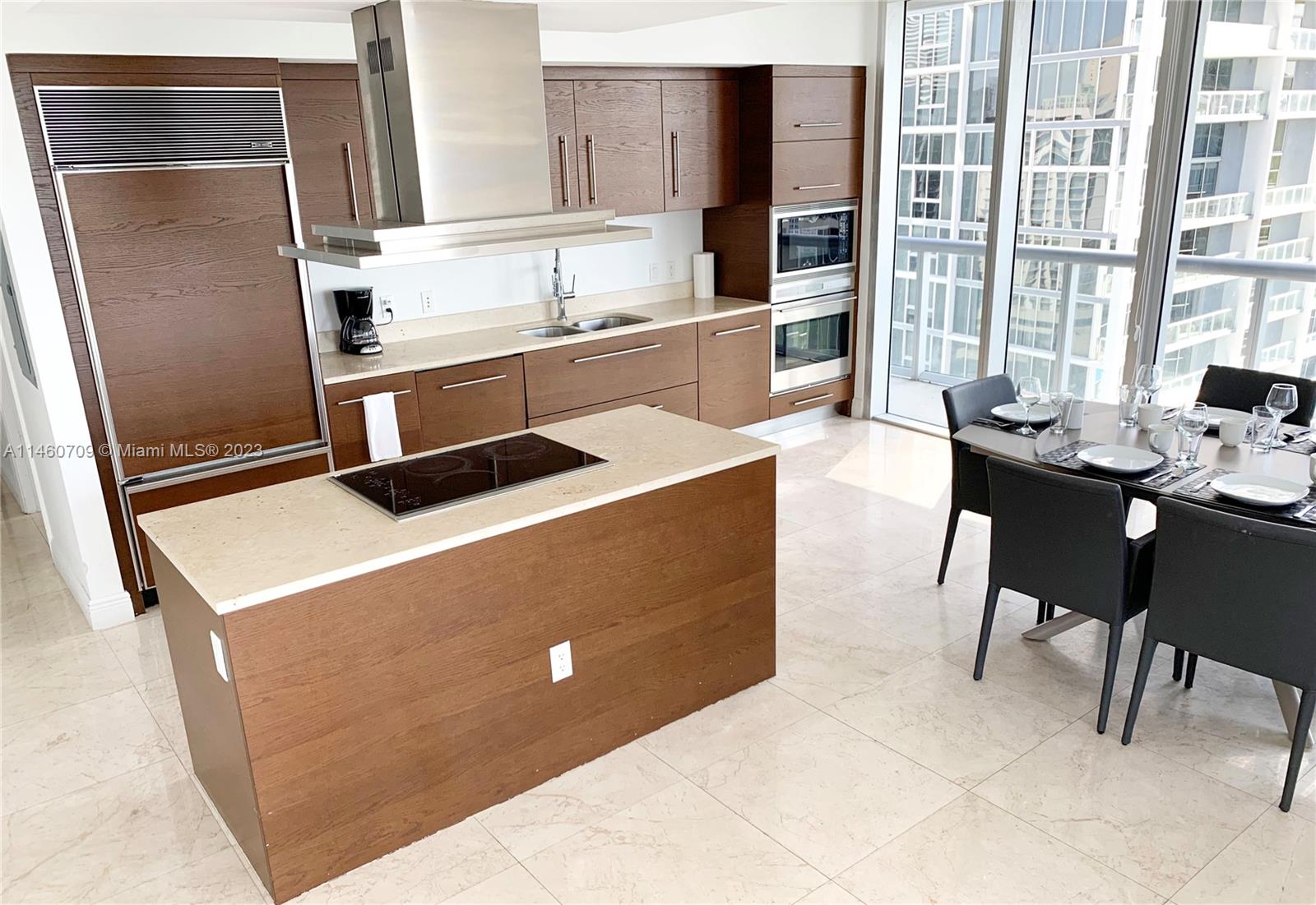 Brickell Miami, FL 33131 - Photo 6 of 27 a kitchen with stainless steel appliances granite countertop a sink stove and refrigerator