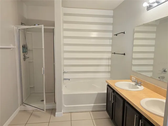 a bathroom with a shower and a sink