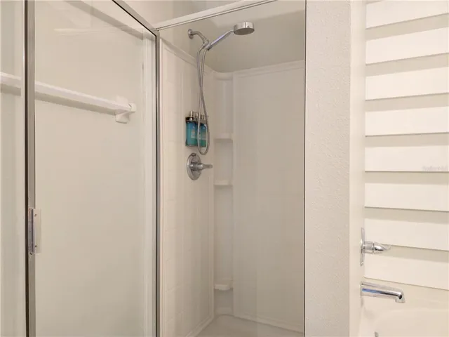 a view of an empty room with a ceiling fan