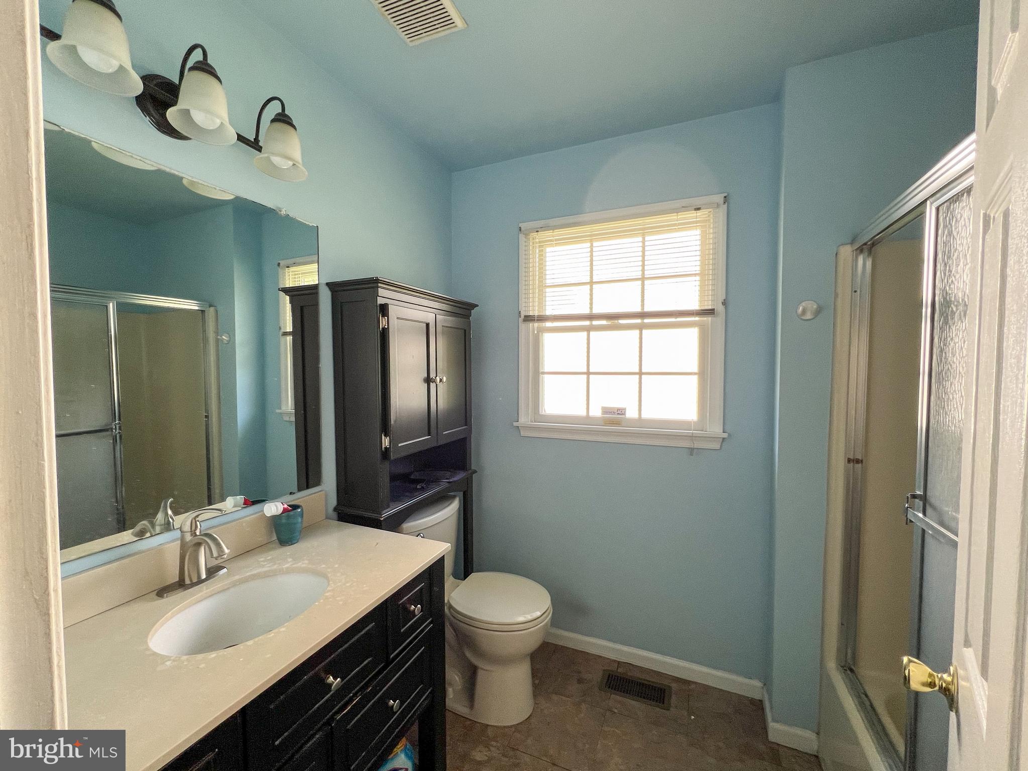 214 Mt Vernon Drive Bear, DE 19701 - Photo 15 of 44 a bathroom with a granite countertop sink toilet a large mirror a shower and a window