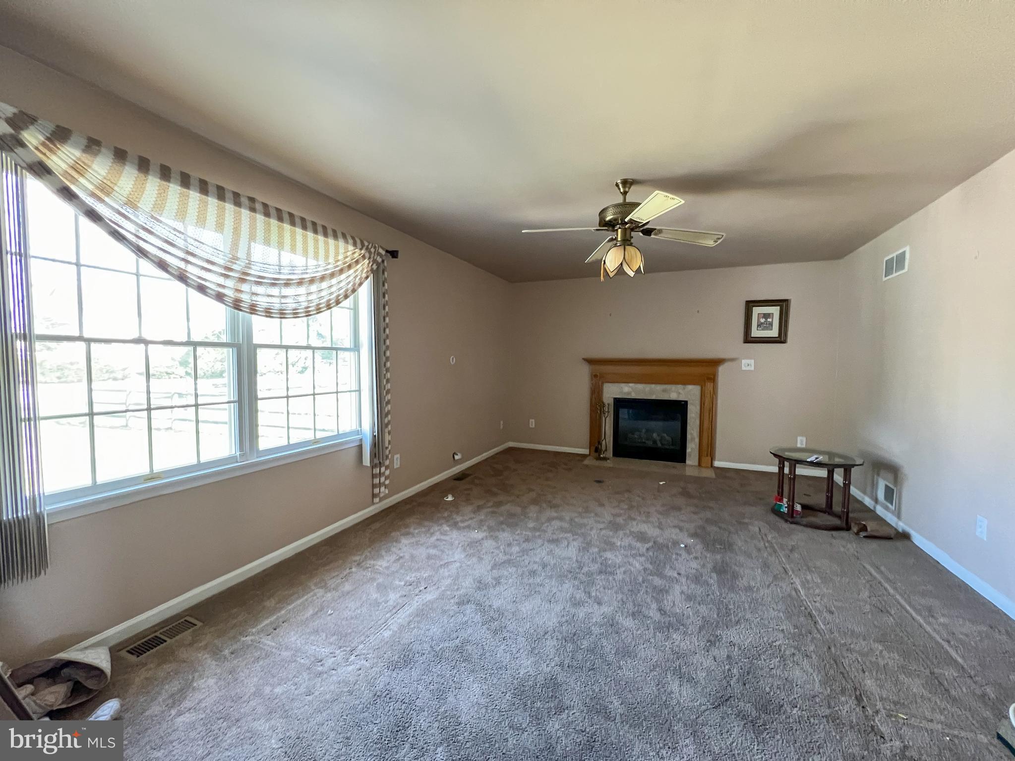 214 Mt Vernon Drive Bear, DE 19701 - Photo 3 of 44 an empty room with windows and a fireplace
