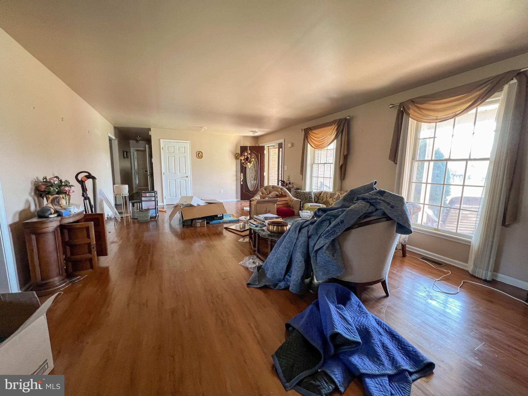 214 Mt Vernon Drive Bear, DE 19701 - Photo 5 of 44 a living room with furniture a wooden floor and a large window