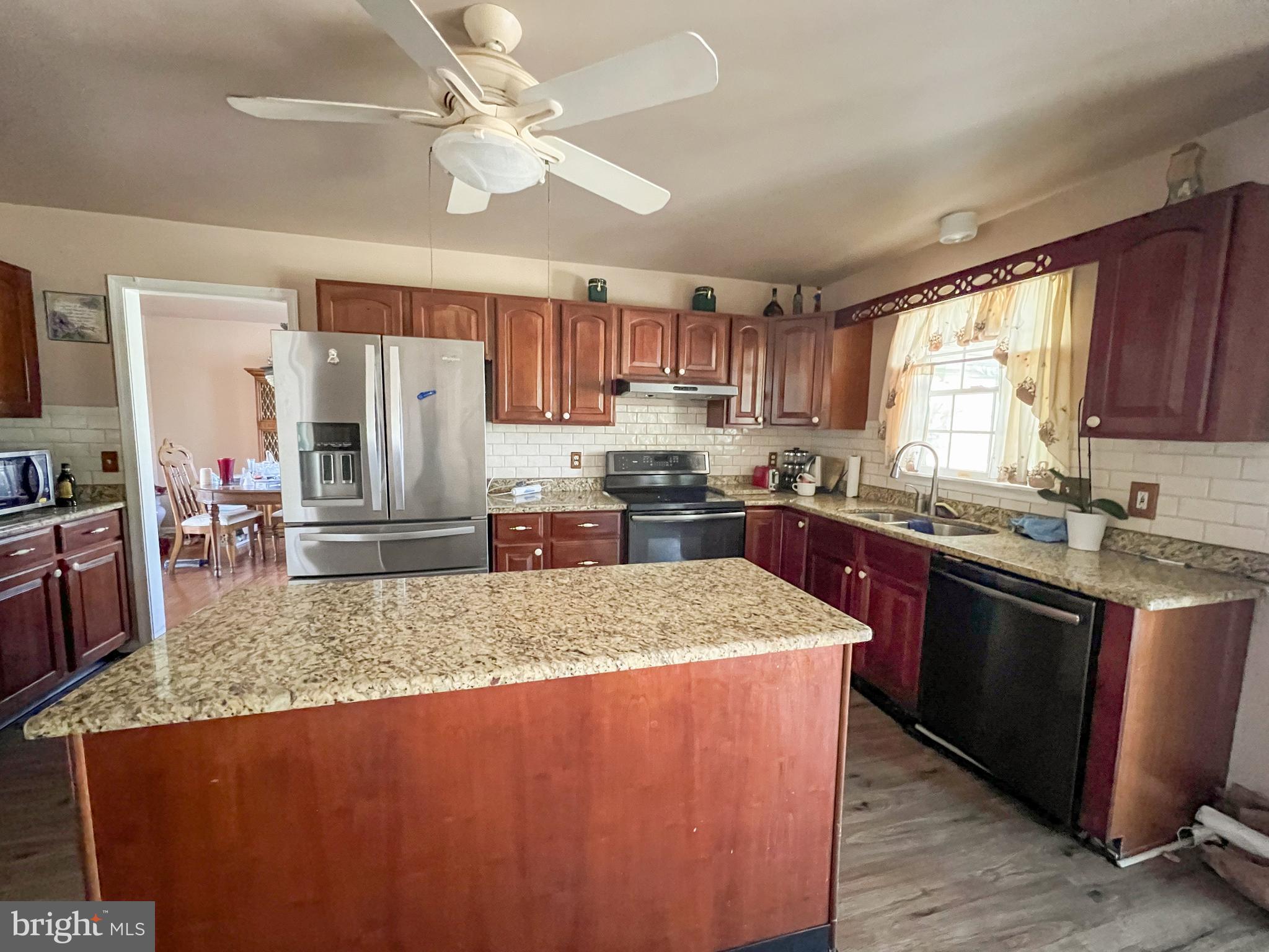 214 Mt Vernon Drive Bear, DE 19701 - Photo 9 of 44 a kitchen with stainless steel appliances granite countertop a sink a stove and a refrigerator