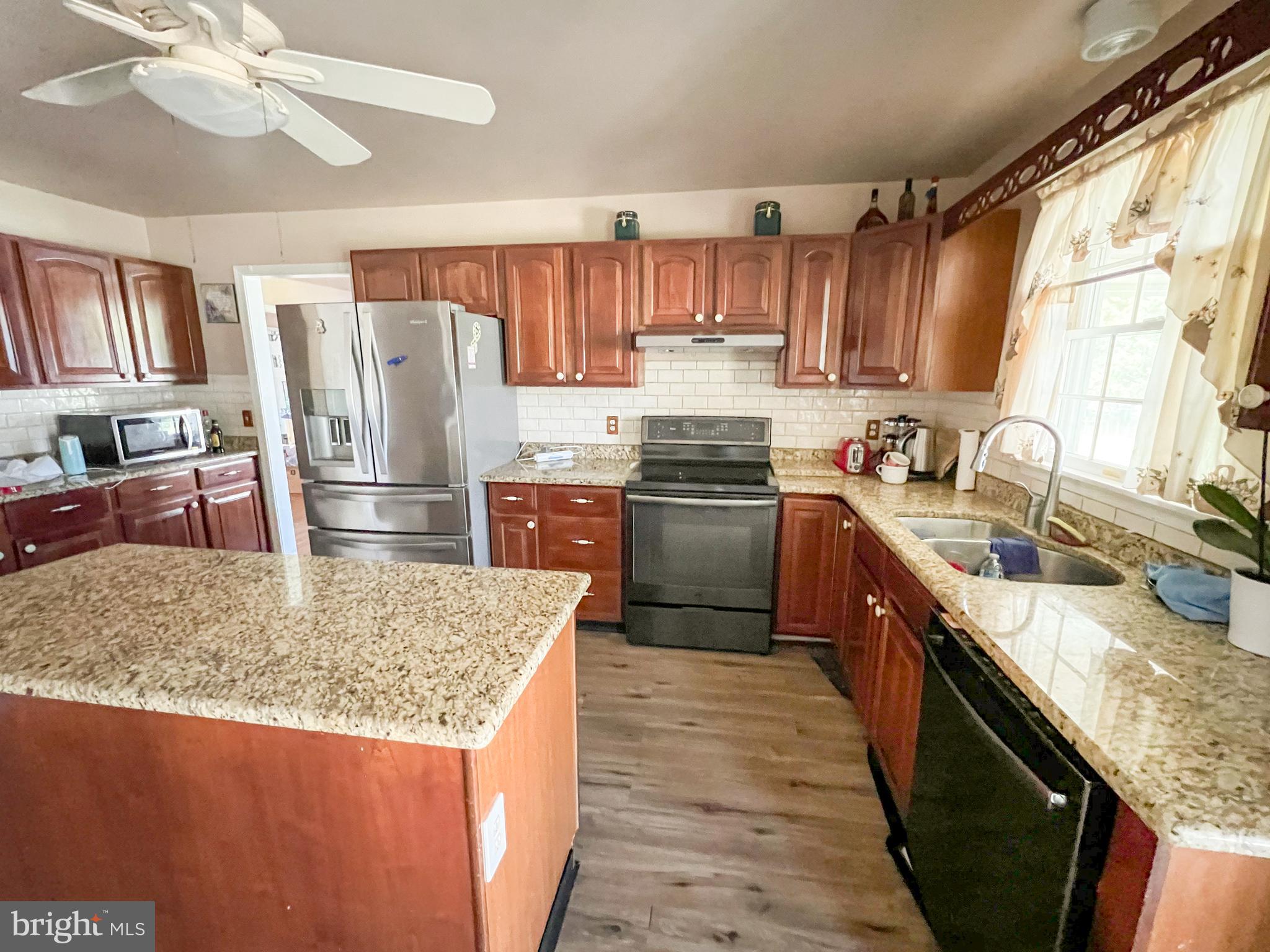 214 Mt Vernon Drive Bear, DE 19701 - Photo 10 of 44 a kitchen with stainless steel appliances granite countertop a sink stove and refrigerator