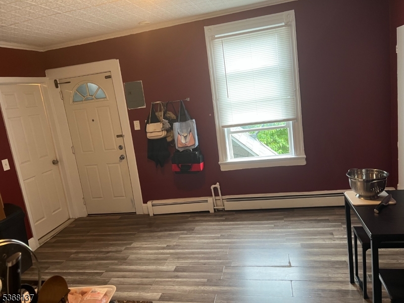 21 Chadwick Street Paterson, NJ 07503 - Photo 12 of 14 a view of a room with wooden floor and window