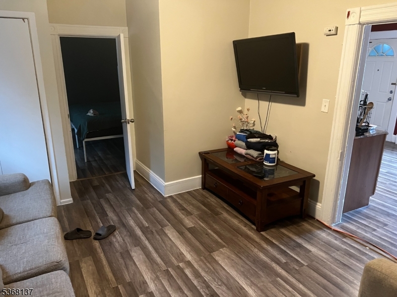 21 Chadwick Street Paterson, NJ 07503 - Photo 3 of 14 a living room with furniture flat screen tv and a fireplace