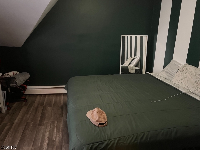 21 Chadwick Street Paterson, NJ 07503 - Photo 7 of 14 a bedroom with a bed and a rug