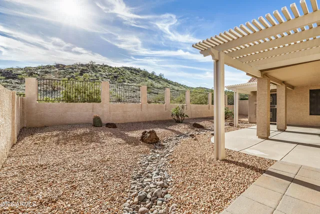 a view of a house with backyard sitting area and garden