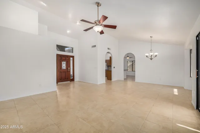 a view of a livingroom with a ceiling fan window and a ceiling fan