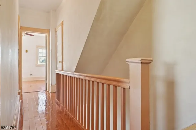 a view of a hallway with wooden floor and entryway