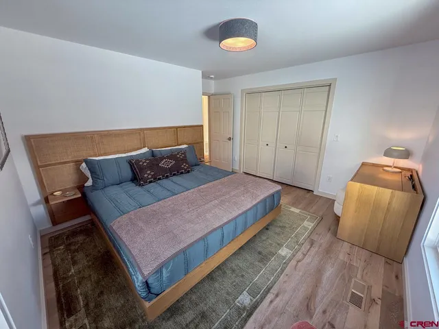 a bed sitting in a bedroom next to a window