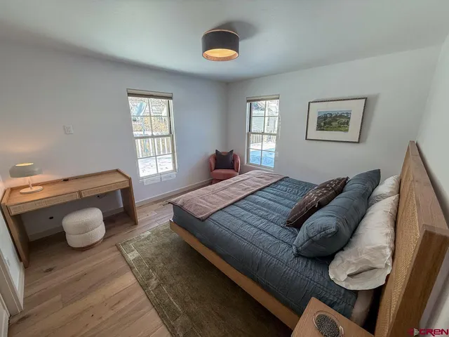 a bedroom with furniture and a window