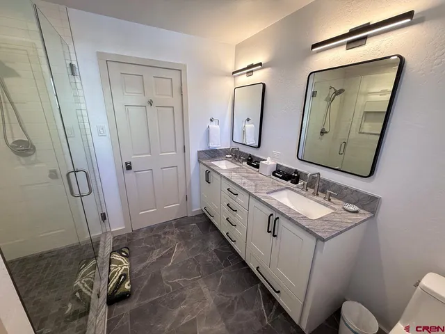 a bathroom with a sink a mirror and a toilet