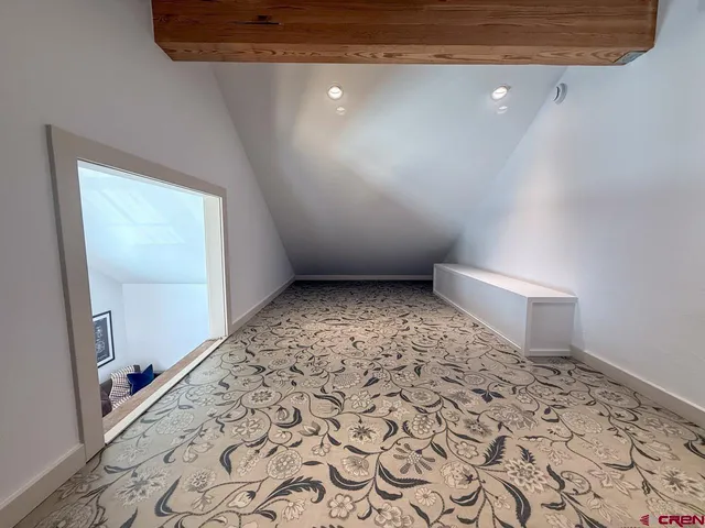 an empty room with a rug