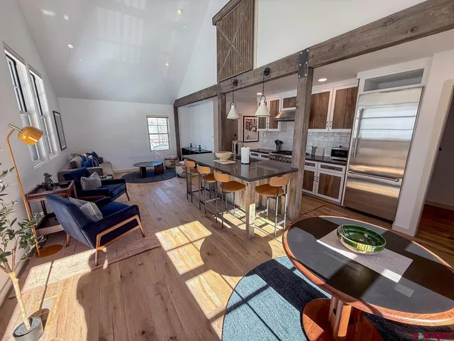 a living room with dining room and wooden floor