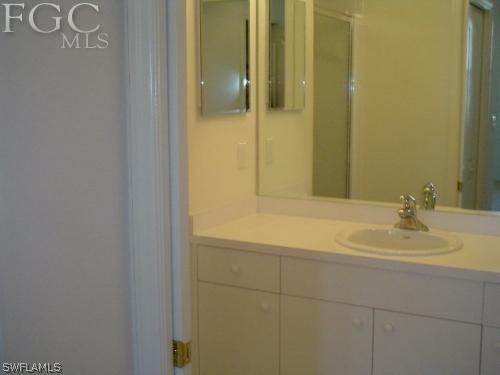 8570 Kingbird Loop, Unit 537 Estero, FL 33967 - Photo 5 of 8 a bathroom with a sink and a mirror