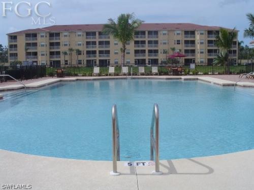 8570 Kingbird Loop, Unit 537 Estero, FL 33967 - Photo 6 of 8 a front view of a building with glass windows and door