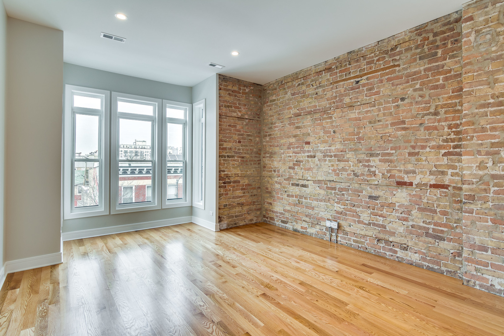 965 West 18th Street Chicago, IL 60608 - Photo 11 of 46 a view of an empty room with a window and wooden floor