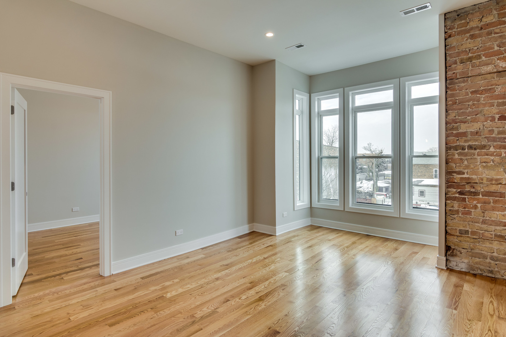 965 West 18th Street Chicago, IL 60608 - Photo 12 of 46 a view of an empty room with wooden floor and a window