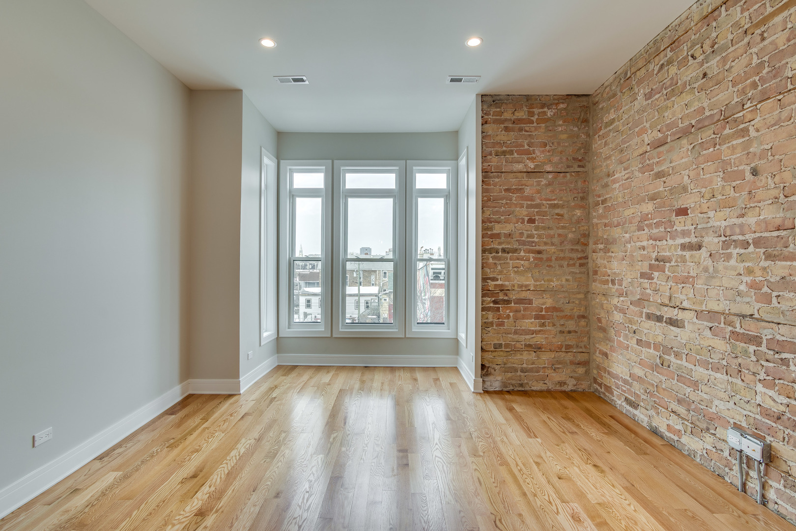 965 West 18th Street Chicago, IL 60608 - Photo 13 of 46 a view of empty room with wooden floor and fan