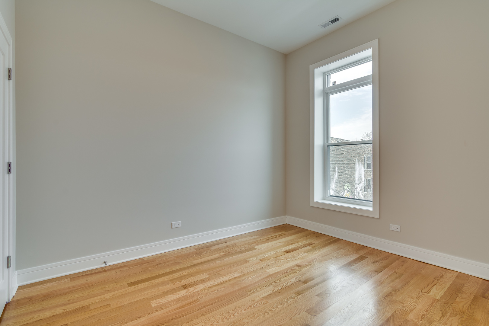 965 West 18th Street Chicago, IL 60608 - Photo 14 of 46 an empty room with wooden floor and windows