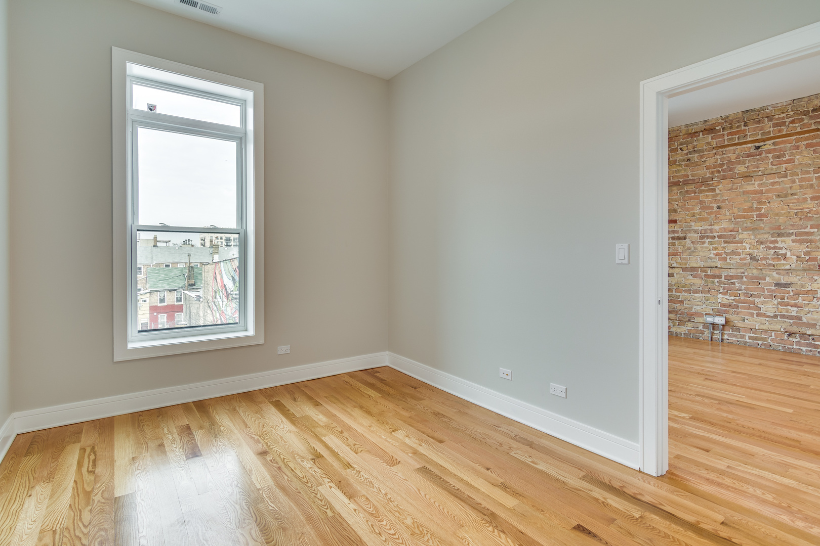 965 West 18th Street Chicago, IL 60608 - Photo 15 of 46 an empty room with wooden floor and a window