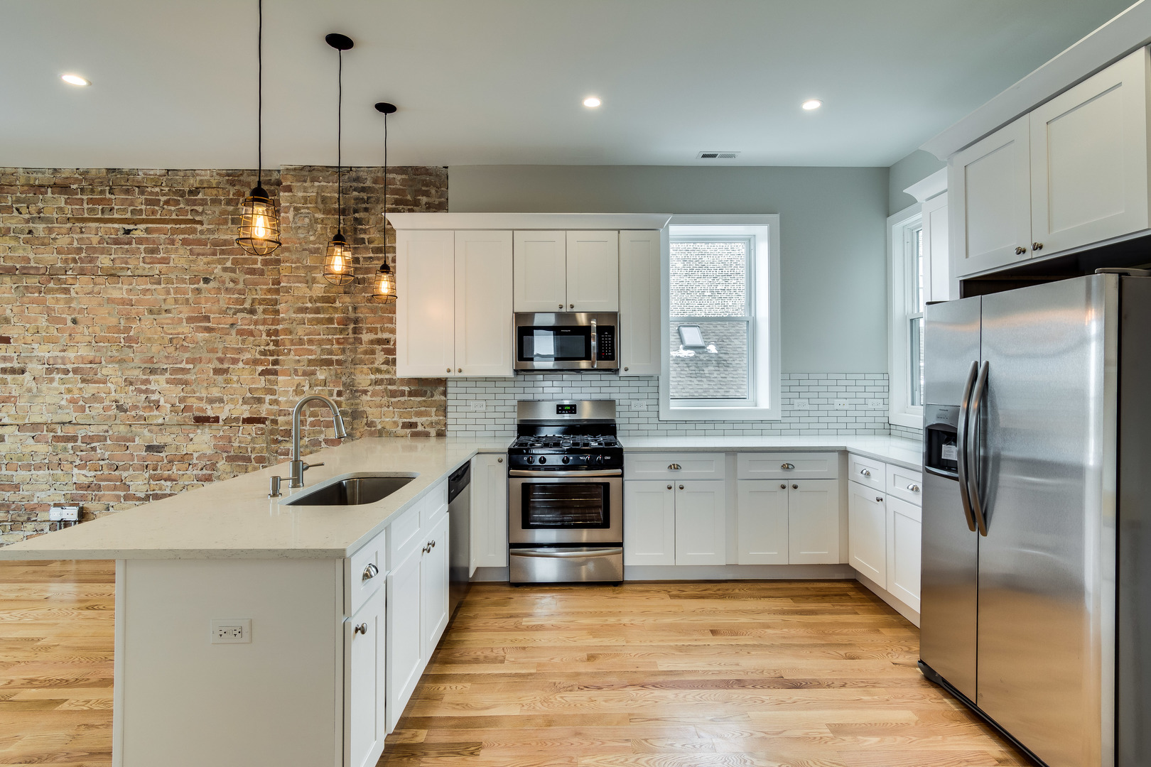 965 West 18th Street Chicago, IL 60608 - Photo 25 of 46 a kitchen with stainless steel appliances kitchen island granite countertop a refrigerator stove and sink