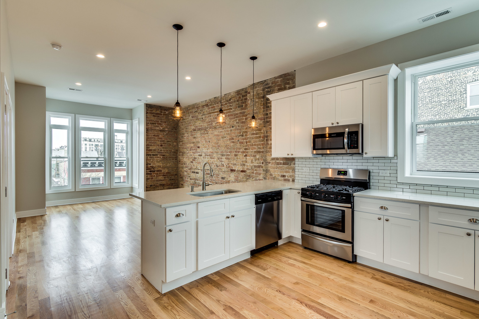 965 West 18th Street Chicago, IL 60608 - Photo 26 of 46 a kitchen with stainless steel appliances granite countertop a sink stove and wooden floor
