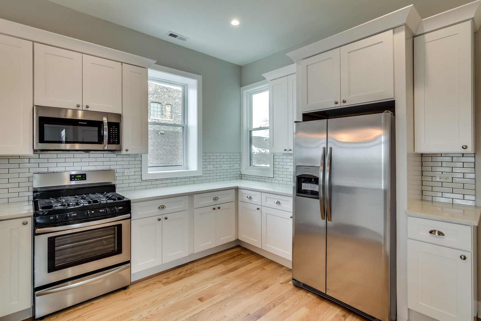 965 West 18th Street Chicago, IL 60608 - Photo 28 of 46 a kitchen with granite countertop a refrigerator stove and microwave
