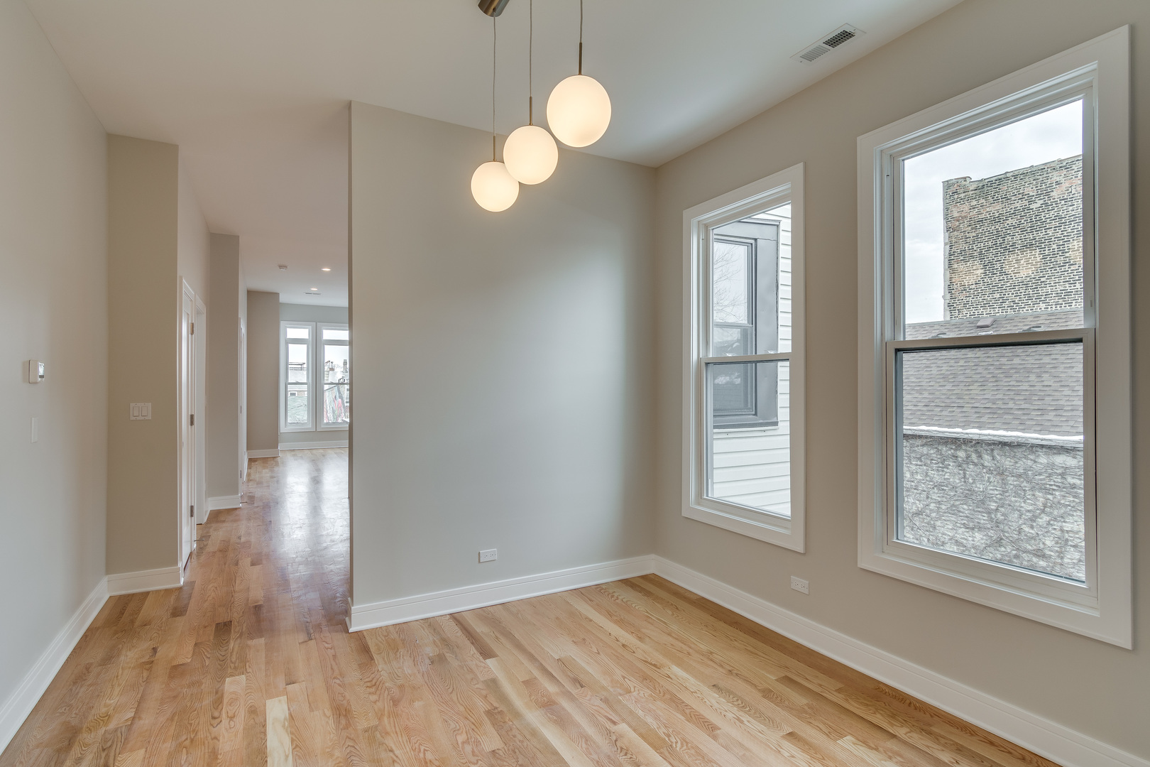 965 West 18th Street Chicago, IL 60608 - Photo 29 of 46 a view of an empty room with wooden floor and a window