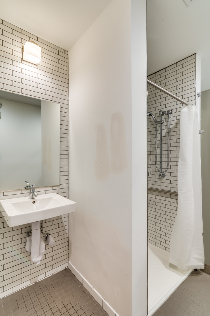 965 West 18th Street Chicago, IL 60608 - Photo 10 of 46 a bathroom with a sink and a mirror